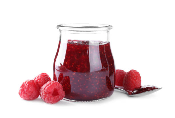 istock Delicious jam and fresh raspberries isolated on white 1351442151