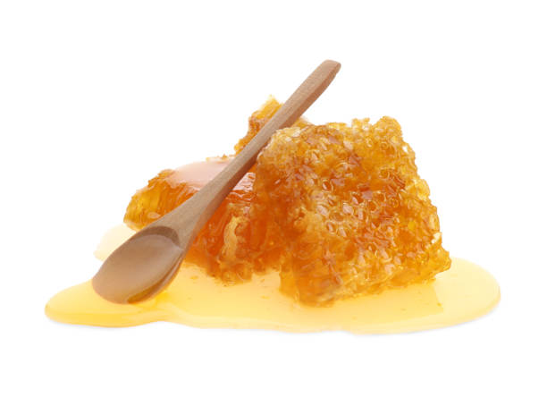 istock Fresh honeycombs and spoon on white background 1351442473