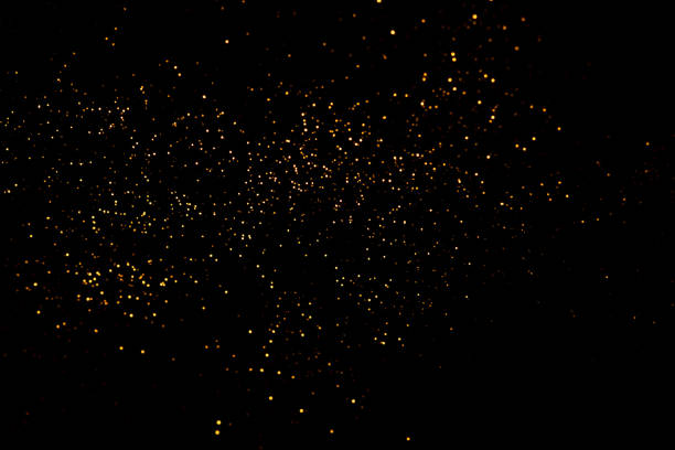 istock Golden abstract bokeh on black background. 1351443446