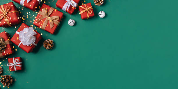 istock Gift boxes with white and brown bows on a green backdrop. 1351443632