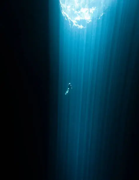 A Japanese Freediver exploring a Cenote without fins
