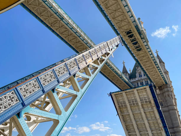 Road sections of Tower Bridge in the raised position London, England - August 2021: Tower Bridge opening to allow a boat to pass down the River Thames tower bridge london england bridge europe stock pictures, royalty-free photos & images