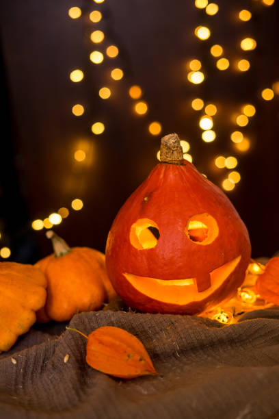 istock orange pumpkins on the background and blurry lights. halloween concept. 1351444106