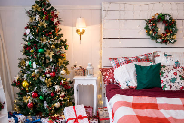 istock Spacious white light bedroom in a loft style with a decorated Christmas spruces 1351444825