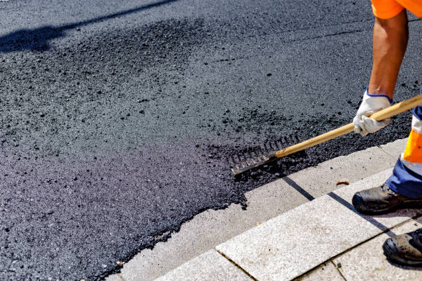 istock Worker spreads asphalt on the road with a rake 1351444834