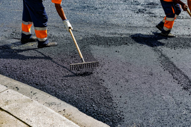 istock Workers spreads asphalt on the road with a rake 1351444839