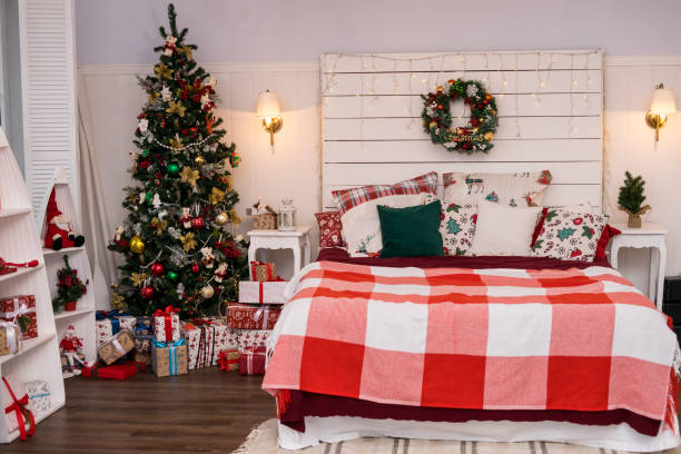 istock Spacious white light bedroom in a loft style with a decorated Christmas spruces 1351444909
