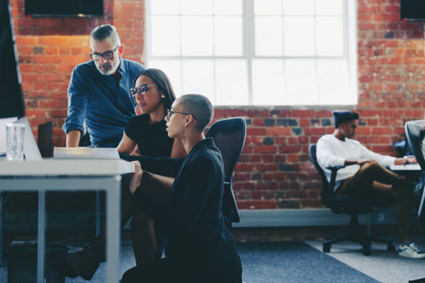 istock Creative businesspeople sharing ideas in a modern office 1351444963