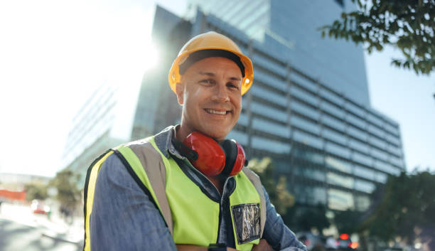 istock Cheerful workman smiling at the camera in the city 1351445131