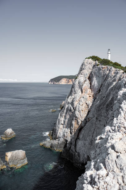 istock Lefkada island sea coast lighthouse on rocky cliff 1351446230