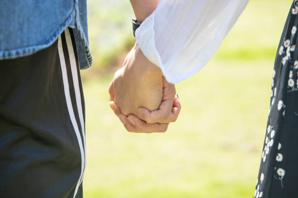 istock Young men and women holding hands 1351446646