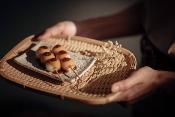 Roasted Mitarashi Dango in the wooden tray, one of the most popular Japanese street food. stock photo