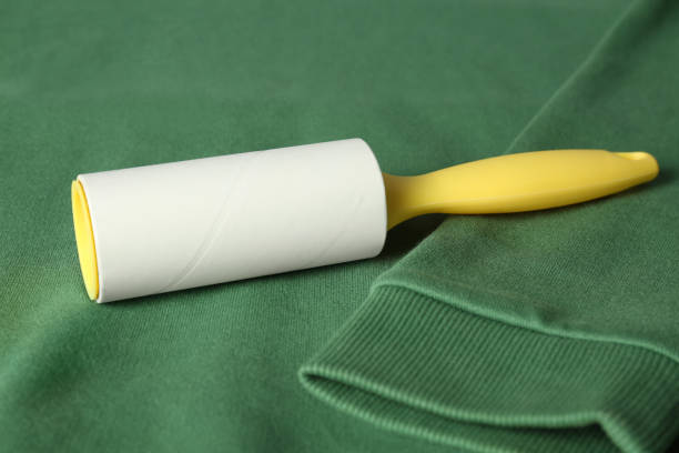 istock New lint roller with yellow handle on green sweatshirt 1351448970