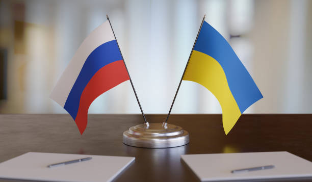 istock Ukrainian and russian flags on table. Negotiation between Russia and Ukraine. 3D rendered illustration. 1351449088