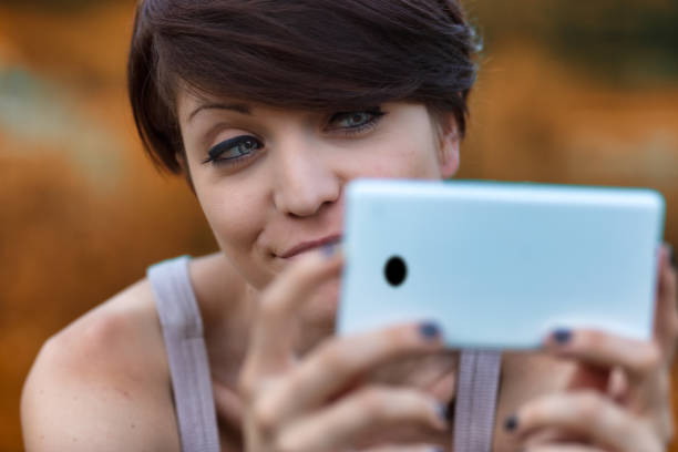 istock Sceptical young woman looking at her mobile phone 1351449939