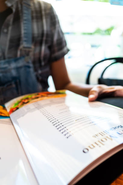 Person consulting the menu of a restaurant