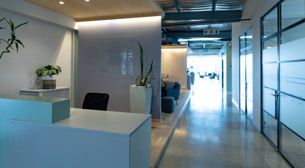 istock Empty chair at reception counter in modern illuminated office 1351451350