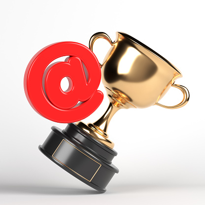 Red-colored 'at' symbol and golden awarding cup. On white-colored background. Square composition with copy space. Isolated with clipping path.