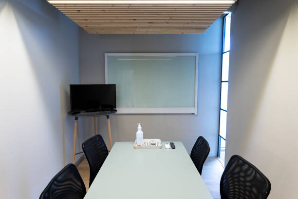 istock Empty chairs in board room with copy space on screens at office 1351452624