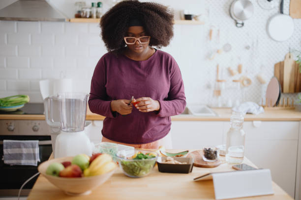 istock Woman preparing fresh fruit smoothie 1351452743