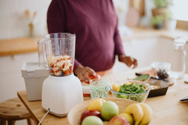 istock Woman preparing fresh fruit smoothie 1351452772