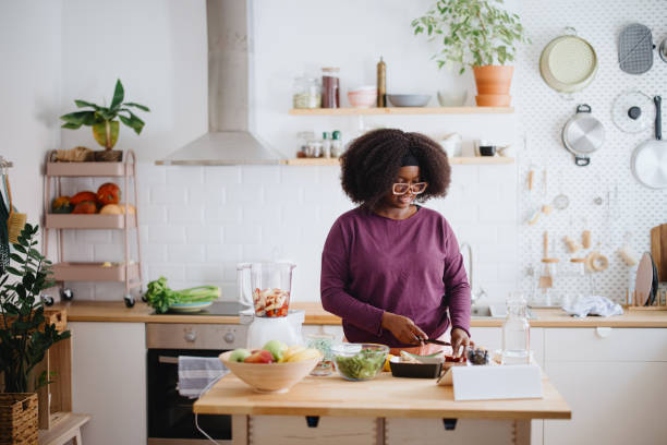 istock Woman preparing fresh fruit smoothie 1351452785