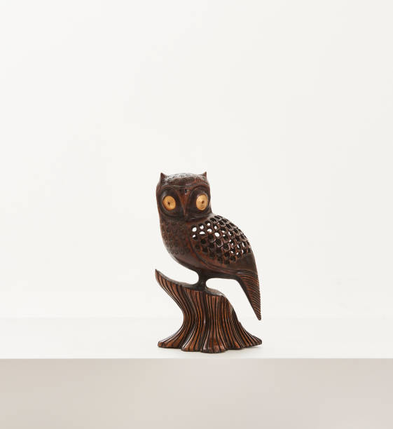 istock white background and wooden owl statue 1351454075