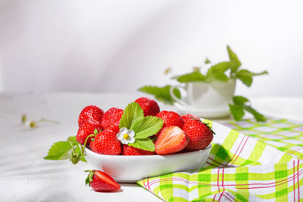 istock Fresh strawberries in a bowl on white stone table 1351455489