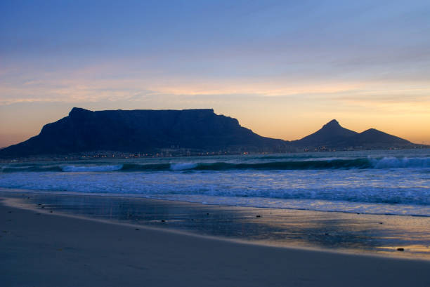 istock Table mountain in the sunset from Lagoon Beach, Milnerton, Cape Town 1351456416