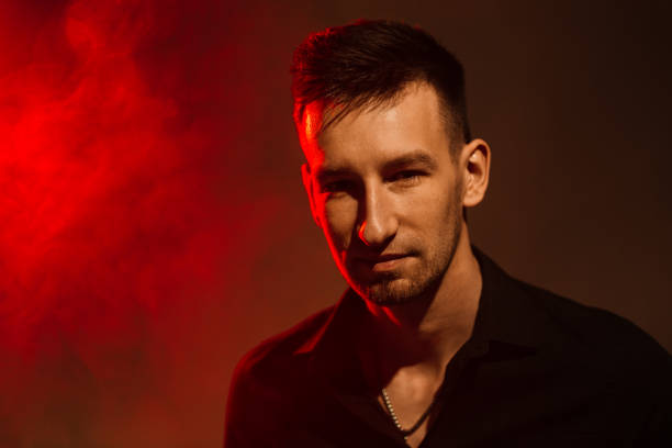 istock young man with smoke and red light. portrait with color combinations 1351456504
