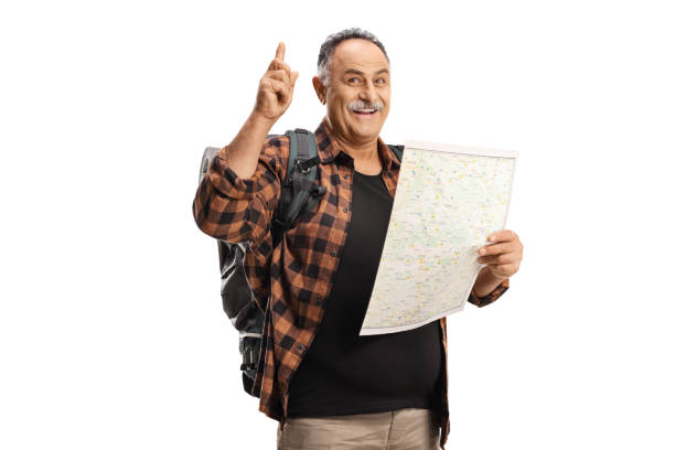 istock Smiling mature hiker holding a map and pointing up 1351458174