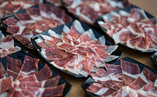 several plates of acorn-fed iberian ham ready to serve stock photo