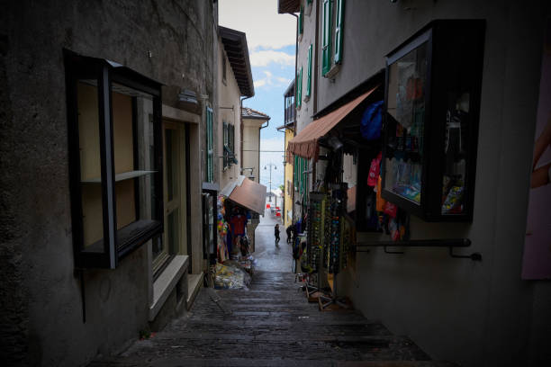 Italy autumn 2021 in the Dolomites. Small tourist city at Lake Garda off season. Gray and rainy day in cozy town Limone. Small streets with shops selling local products based on the lemons produced close by to the tourists.