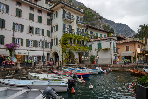 Italy autumn 2021 in the Dolomites. Small tourist city at Lake Garda off season. Gray and rainy day in cozy town Limone. Small streets with shops selling local products based on the lemons produced close by to the tourists.