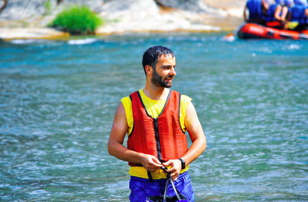 Antalya, Türkiye - October 15, 2013 : Father and son speeding through the canyon stream in a boat. Notes: The Köprüçay River in the Köprülü Canyon National Park in Antalya's Manavgat district is an exciting geography where rafting can be done.