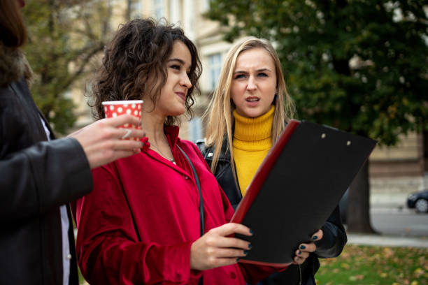 istock Cheerful college students drinking coffee outdoors 1351461536