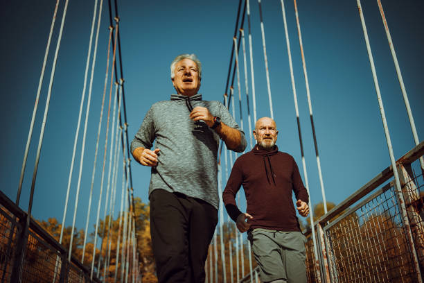 istock Senior friends jogging together 1351465247