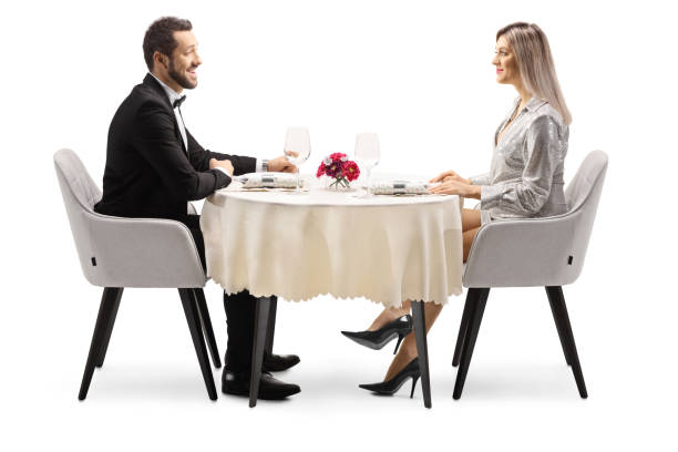 istock Young elegant man and woman sitting at a restaurant table 1351465359