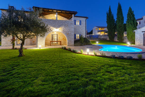 Luxurious beautiful modern villa with swimming pool and yard garden Luxurious beautiful modern villa with swimming pool and yard garden by night, Istria, Croatia villa Landour  stock pictures, royalty-free photos  images