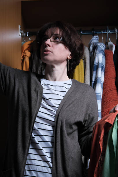 istock Mature woman is organizing her wardrobe 1351468743