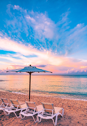 Paradise sandy beach on the Caribbean Sea with sun lounger and parasol