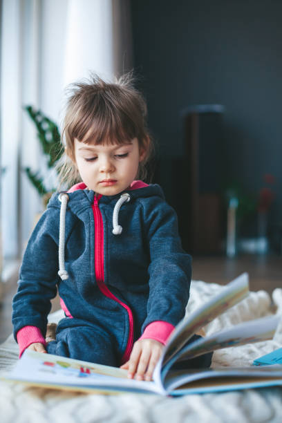 istock little girl reading a book 1351469725