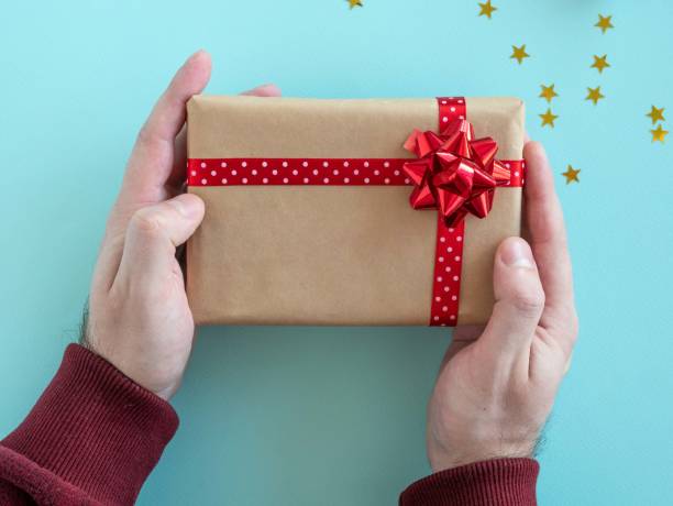 istock Christmas present in men's hands. 1351470543