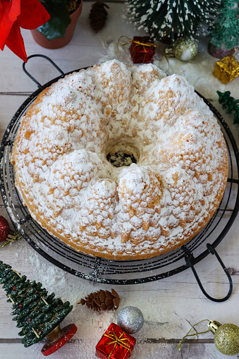 Stock photo showing a close-up view of a freshly baked, homemade, lemon drizzle, bundt cake baked in a Christmas tree cake mould.