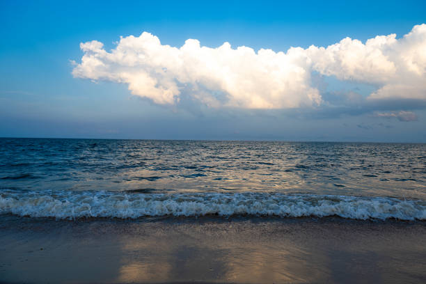 Dramatic sky over Pomorie town and fishers on the Jetty. Bulgaria, Eastern Europe.