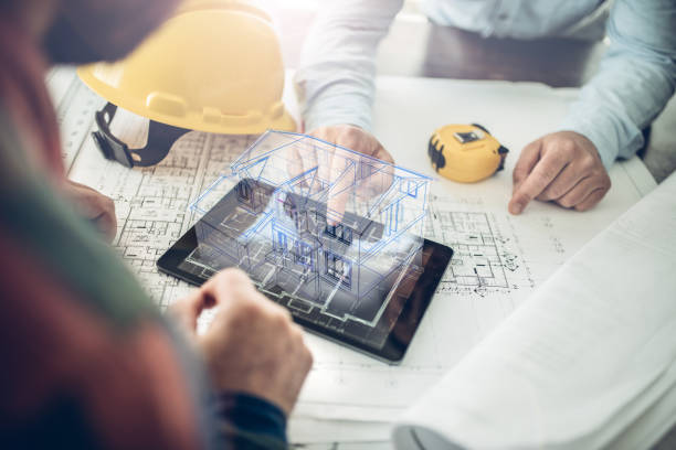 House project in virtual reality Architect and his client looking at the hologram of a house project over a tablet computer. The client is reviewing his future house layout
Note to inspector: I am the author of the building project engineer stock pictures, royalty-free photos & images