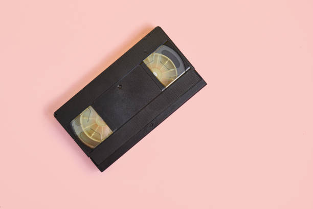 istock videotape on pink background, vintage video cassette copy space 1351474528