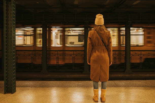 Woman standing in empty subway station
