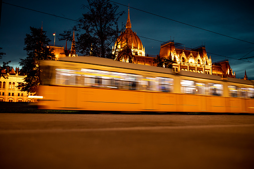 Vienna, Austria - June 7, 2023: Vintage public tram ( streetcar ) for passenger transport on rails in the street of Vienna city, in a night.