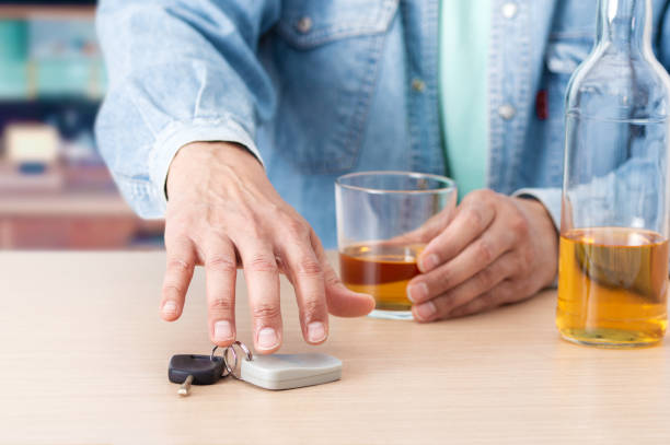 drunk man taking the car key Man hand drinking beer and holding car keys pics of drunk driving accidents stock pictures, royalty-free photos & images